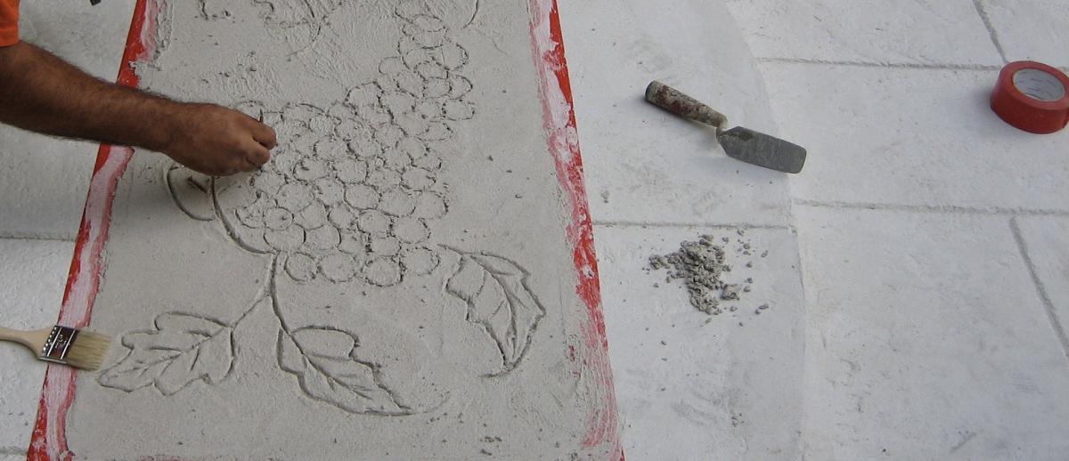 Liquid coating Designs process man etching grapes into stonework